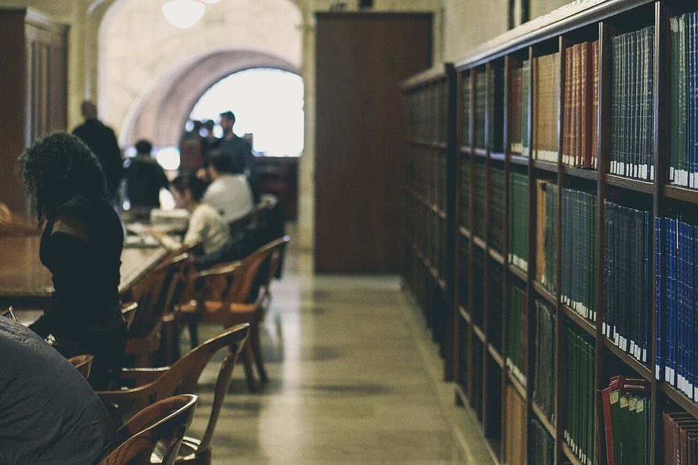 Rows of bookshelves packed with books in an old library