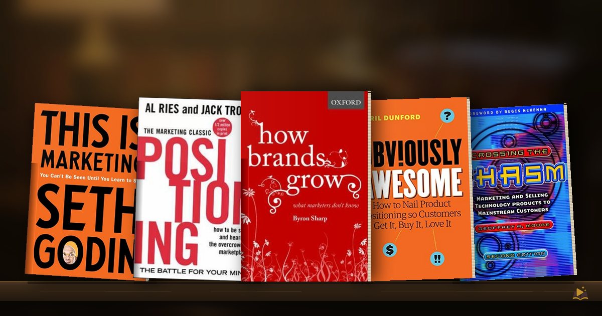 Book covers on a library shelf: This Is Marketing by Seth Godin, Positioning: The Battle for Your Mind by Al Ries Jack Trout, How Brands Grow by Byron Sharp, Obviously Awesome by April Dunford and Crossing the Chasm by Geoffrey A. Moore