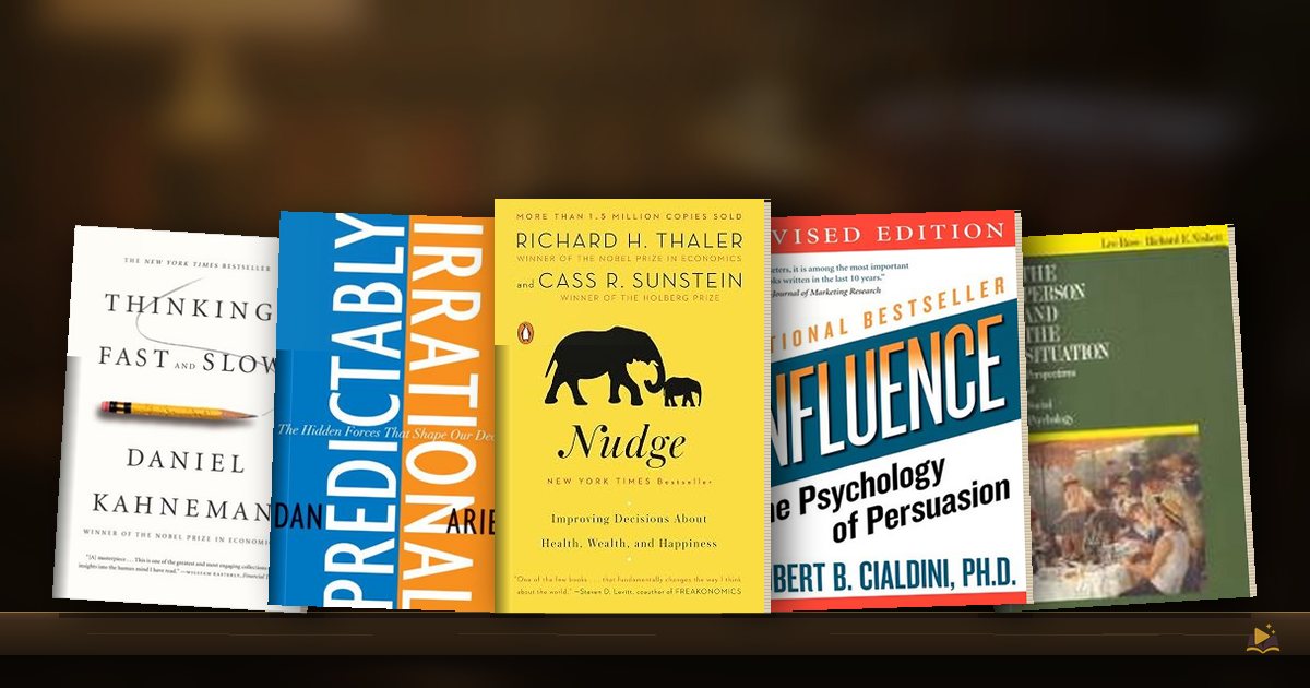 Book covers on a library shelf: Thinking, Fast and Slow by Daniel Kahneman, Predictably Irrational by Dan Ariely, Nudge by Richard Thaler Cass Sunstein, Influence by Robert B. Cialdini and The Person and the Situation by Lee Ross Richard Nisbett